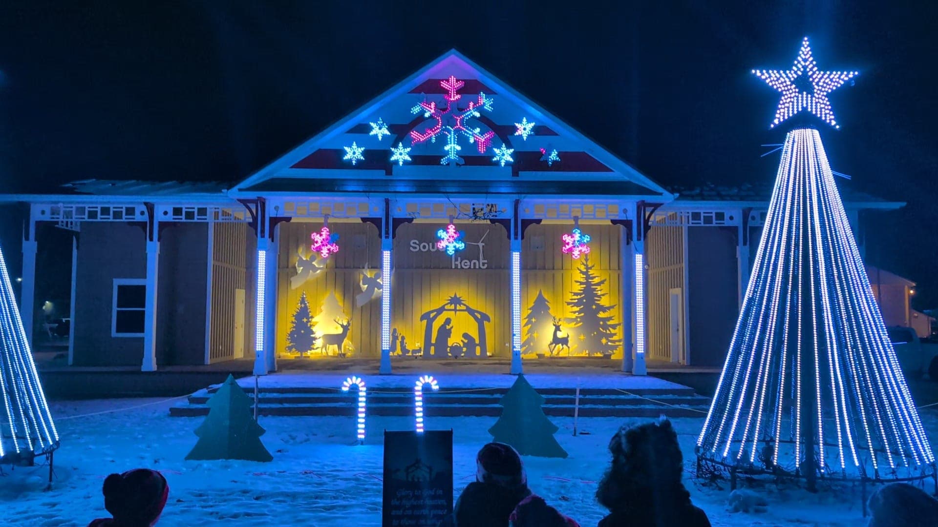 Close view of pixel snowflakes on the pavilion gable and a white mega tree with star